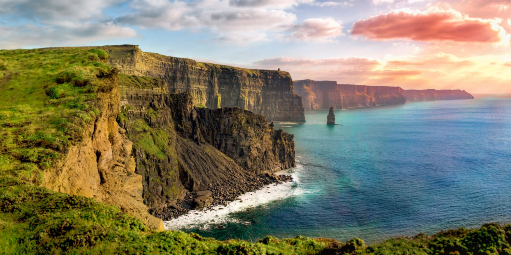 A scenic view of the ocean and cliffs