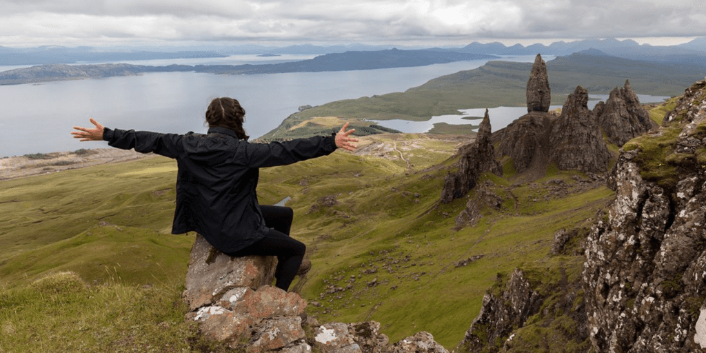 A woman sitting on top of a rock formation