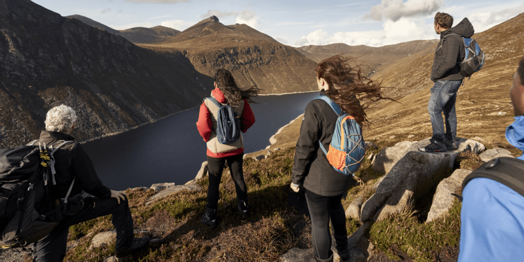 A group of people standing on top of a mountain