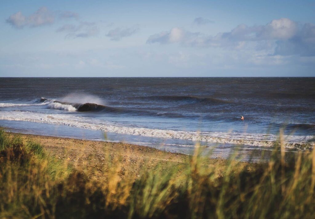 A person riding a surfboard on a wave in the ocean