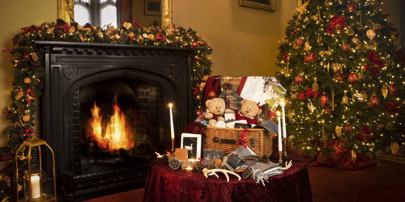 A living room decorated for christmas with a fire place