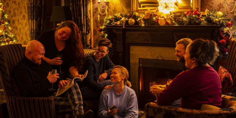 A group of people sitting around a fire place