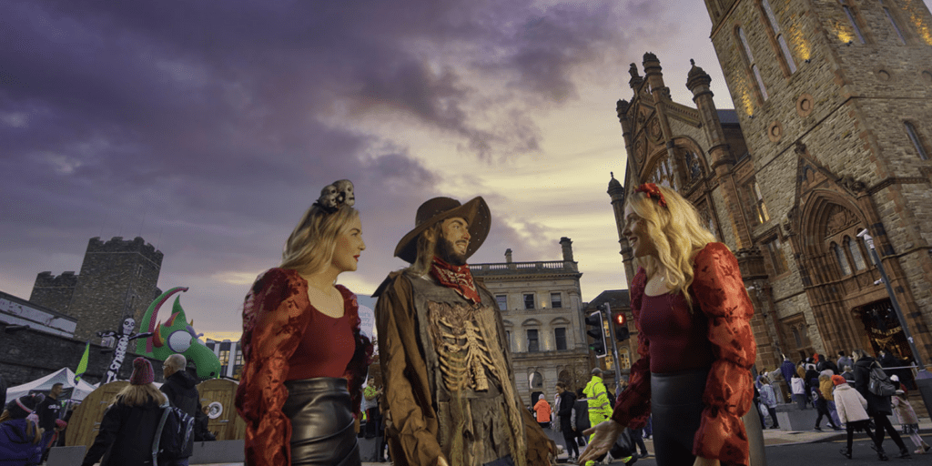 People in costumes that are standing in the street