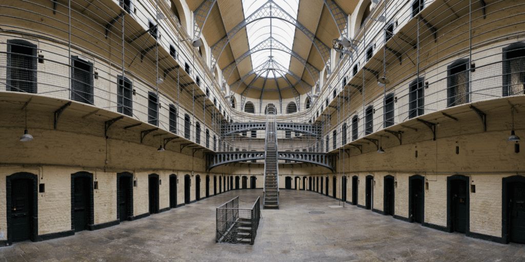 The inside of a hall with a staircase leading up to the second floor