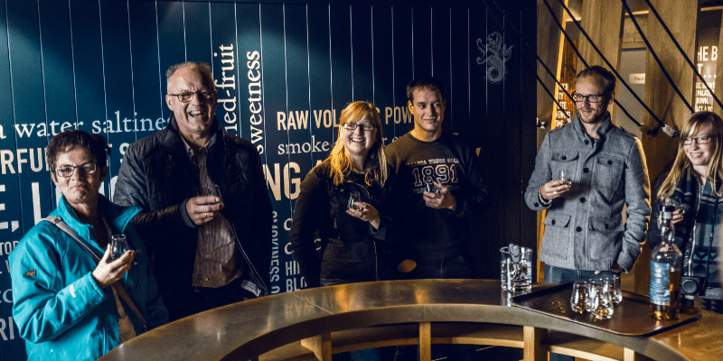 A group of people standing next to each other with glasses