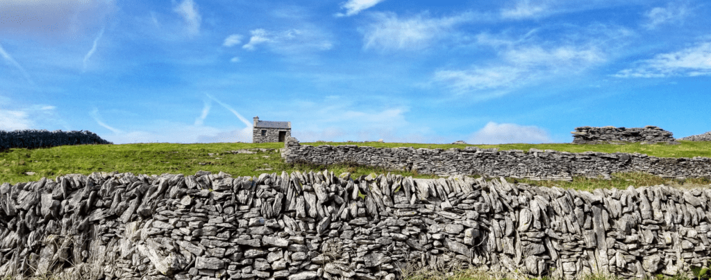 A stone wall with a building on top of it