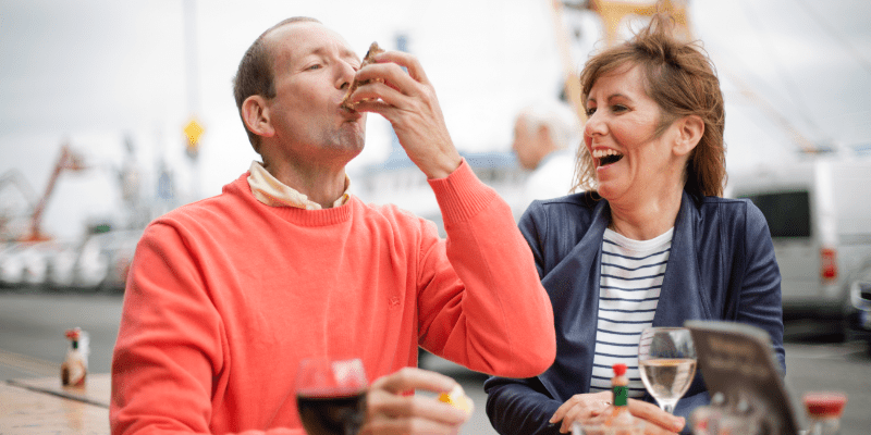 A man and a woman sitting at a table drinking wine