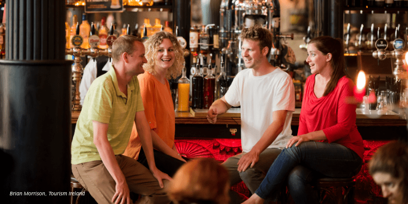 A group of people sitting at a bar