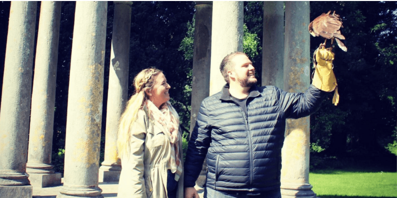 A man and a woman holding a bird in their hands