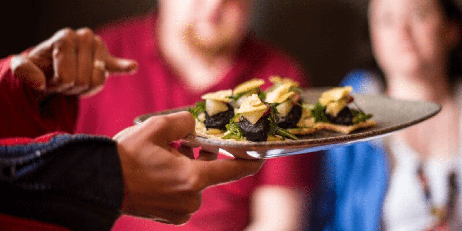 A person holding a plate with food on it