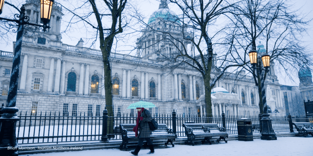 A person walking in the snow with an umbrella