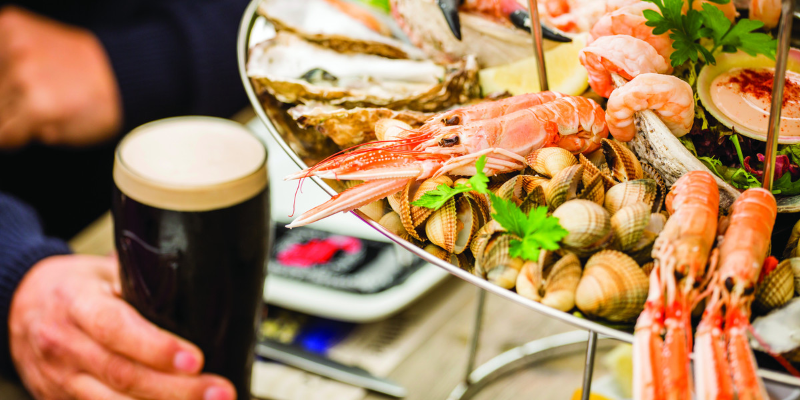 A large platter of seafood and a pint of beer