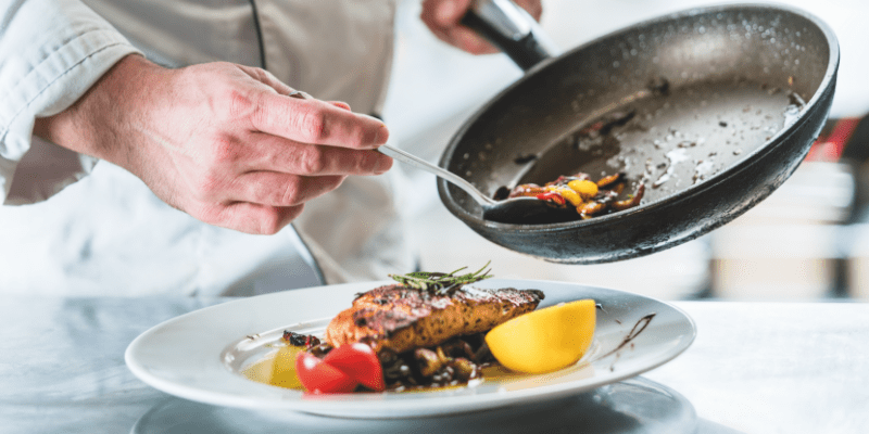 Chef putting food on a plate