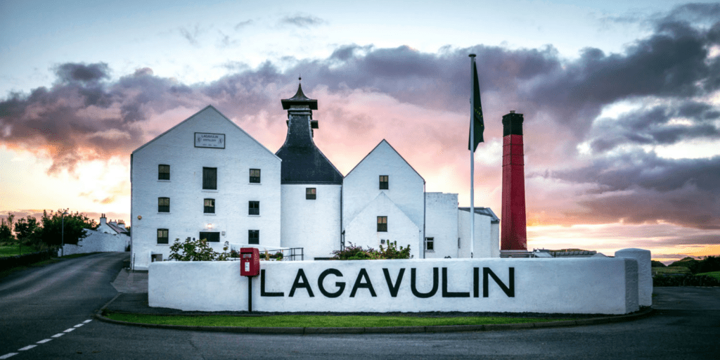 A large white building with a sign in front of it