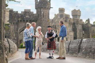 Tourists with Bagpiper at Ashford Castle Ireland