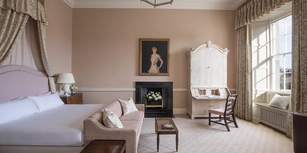 A bedroom with a bed, a desk and a fireplace at Cashel Palace in Ireland