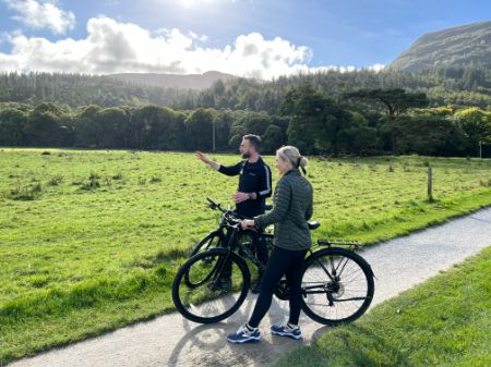 A man and a woman standing next to a bike