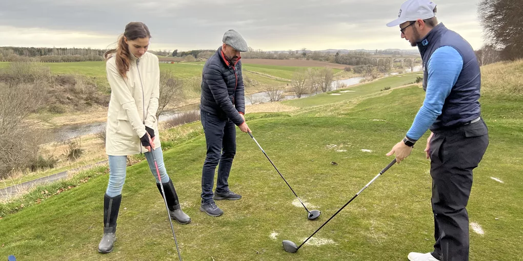 Three people golfing in Scotland
