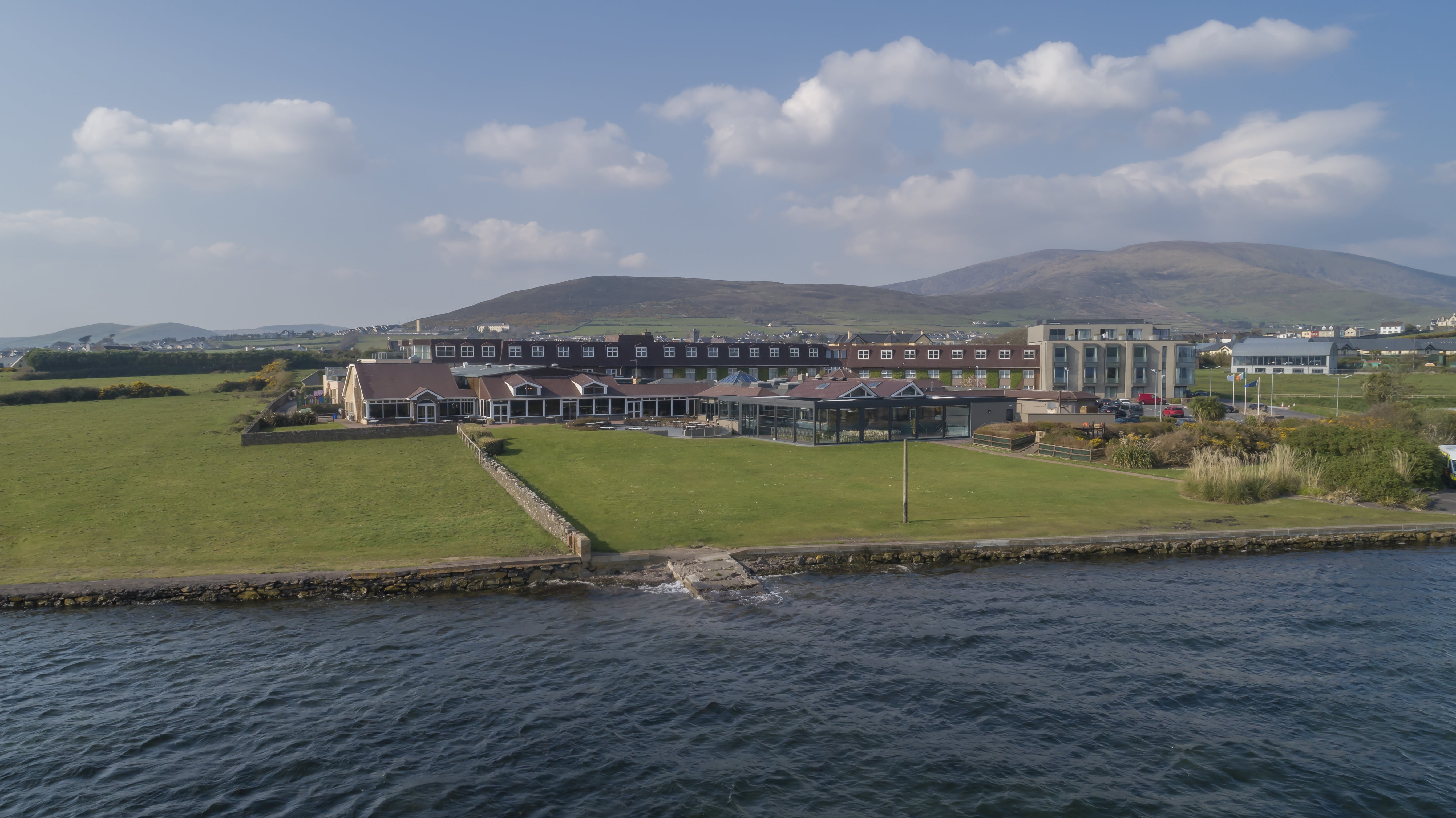 Dingle Skellig Hotel sitting on top of a lush green field