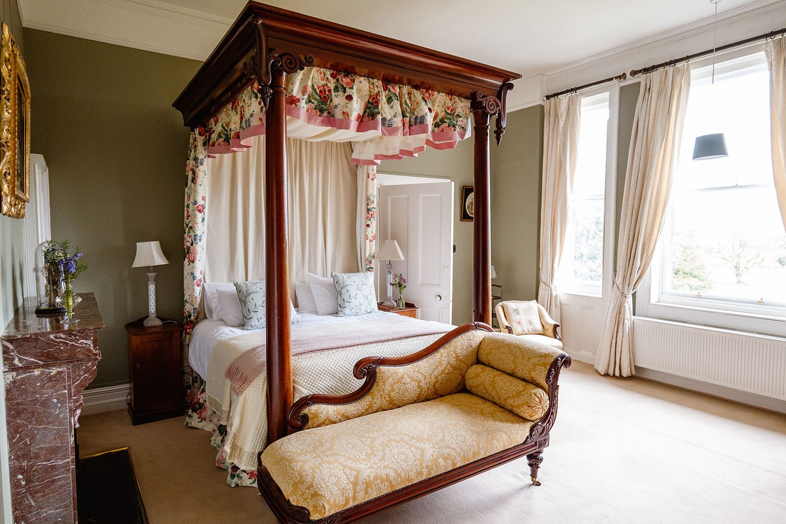 A bedroom with a four poster bed and a fireplace at Clonalis House in Roscommon