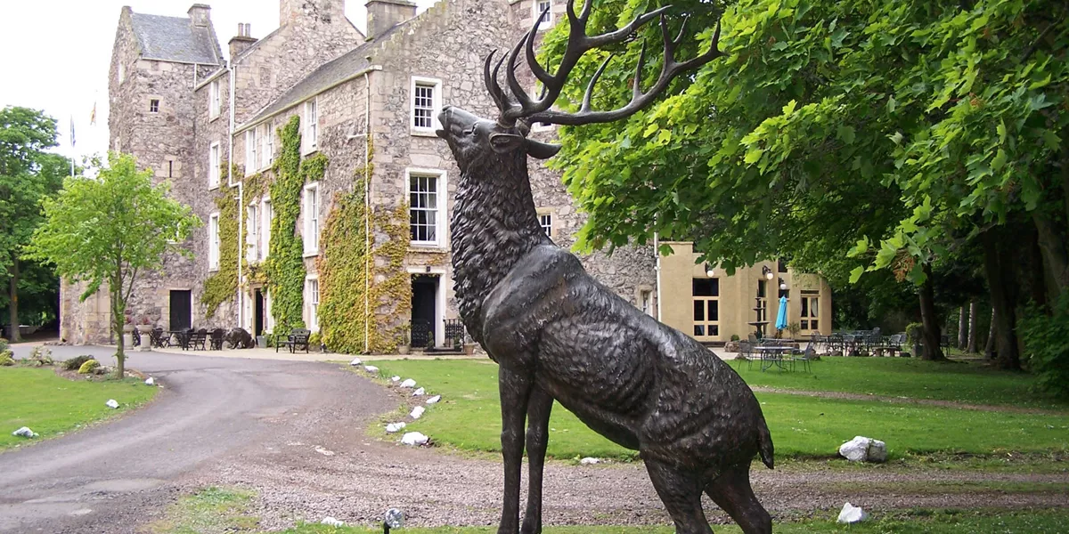 Fernie Castle Exterior with deer statue in Scotland