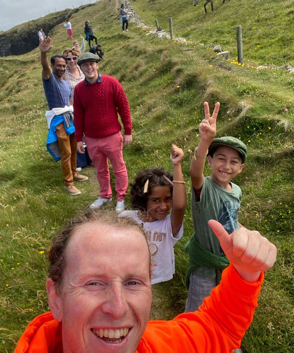 Group of walkers been led by man in orange jacket