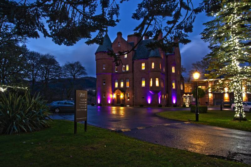 Fonab castle at night, tree lit with fairy lights