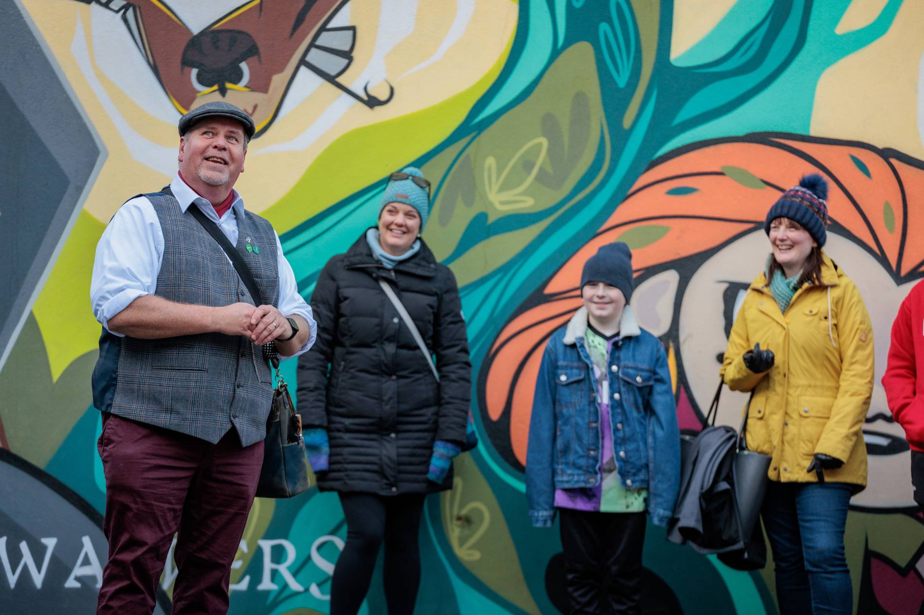 Travellers next to colourful mural in Kilkenny