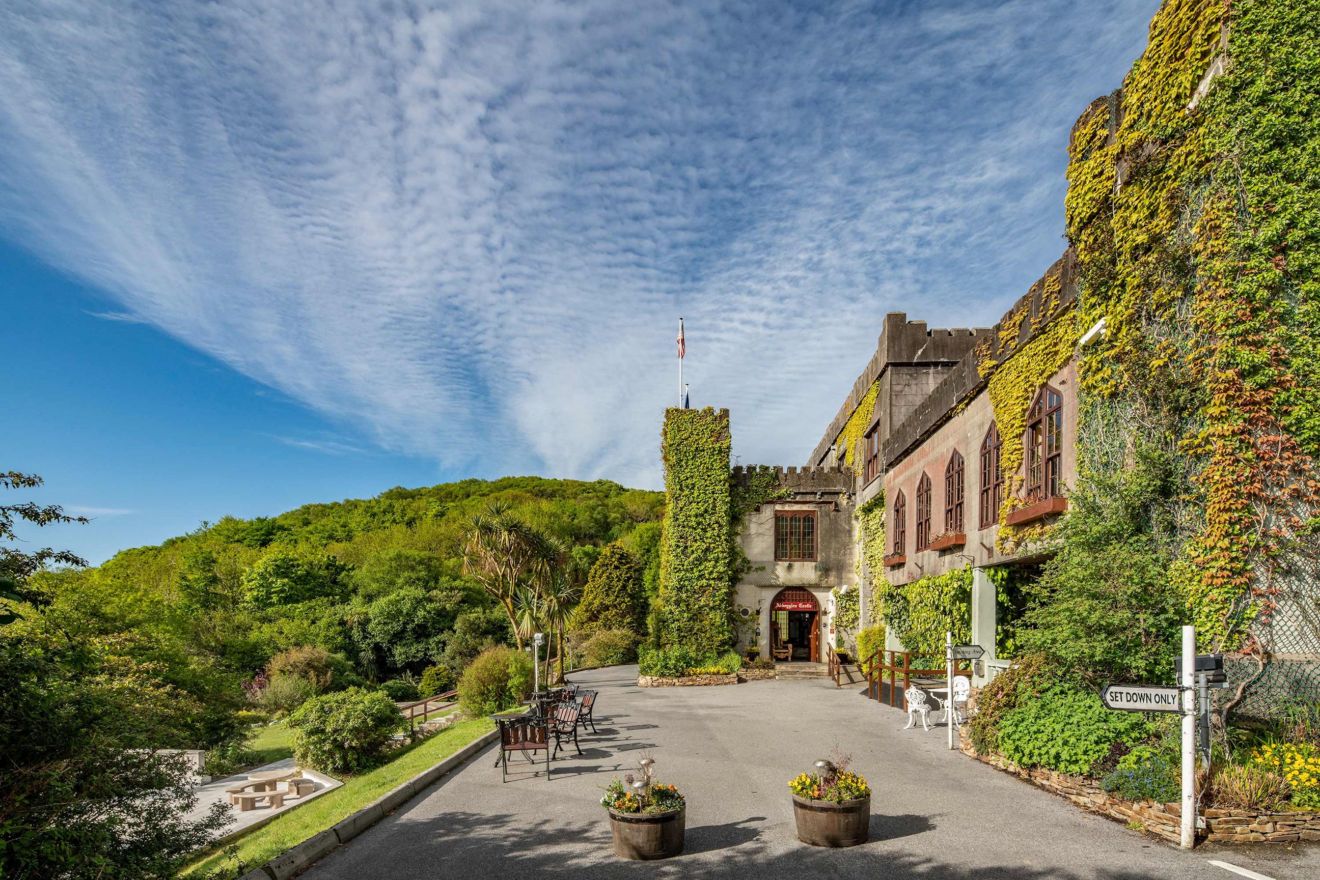 Abbeyglen Castle Hotel with ivy-covered walls and garden seating area