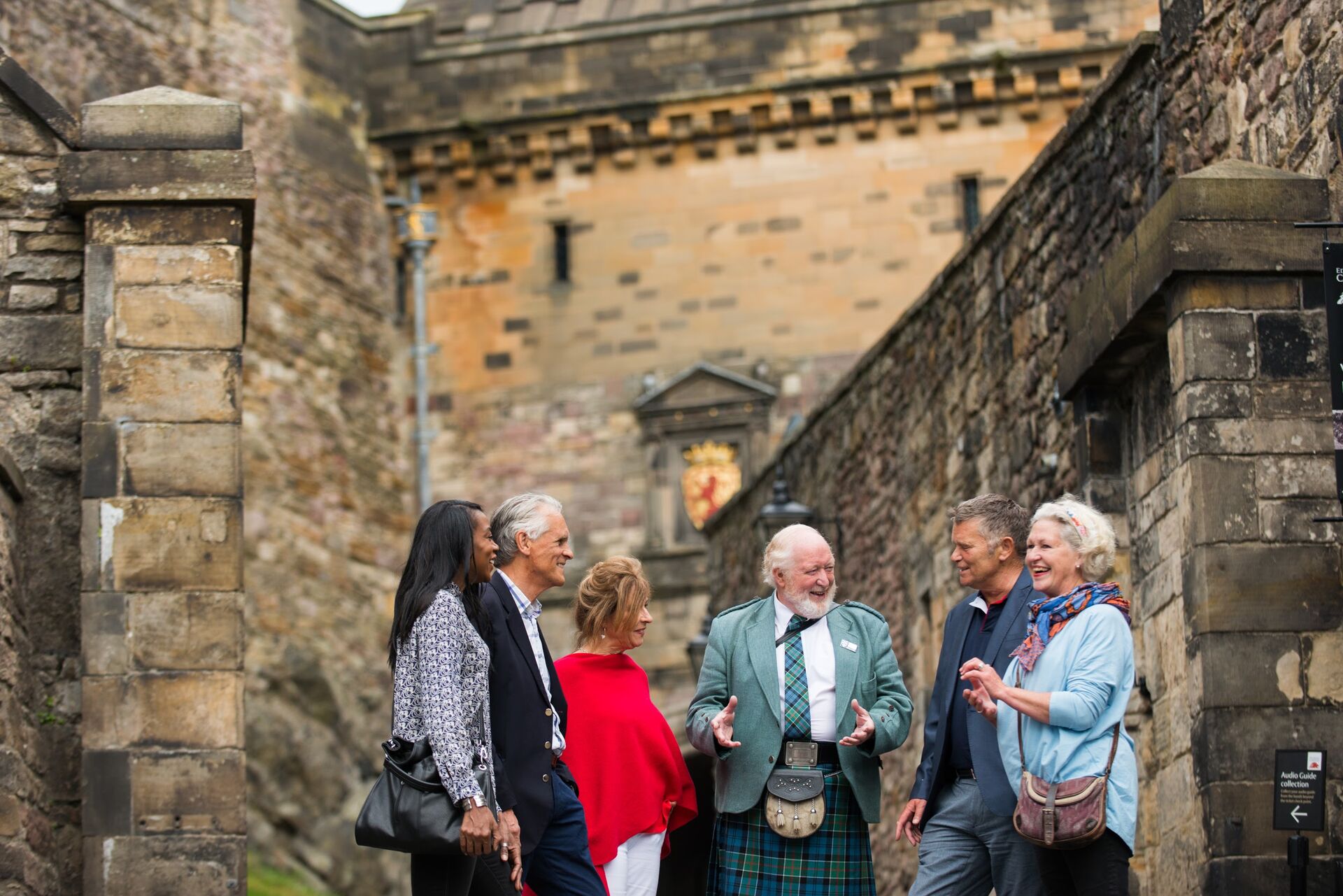 Tour guide in kilt addressing tourists