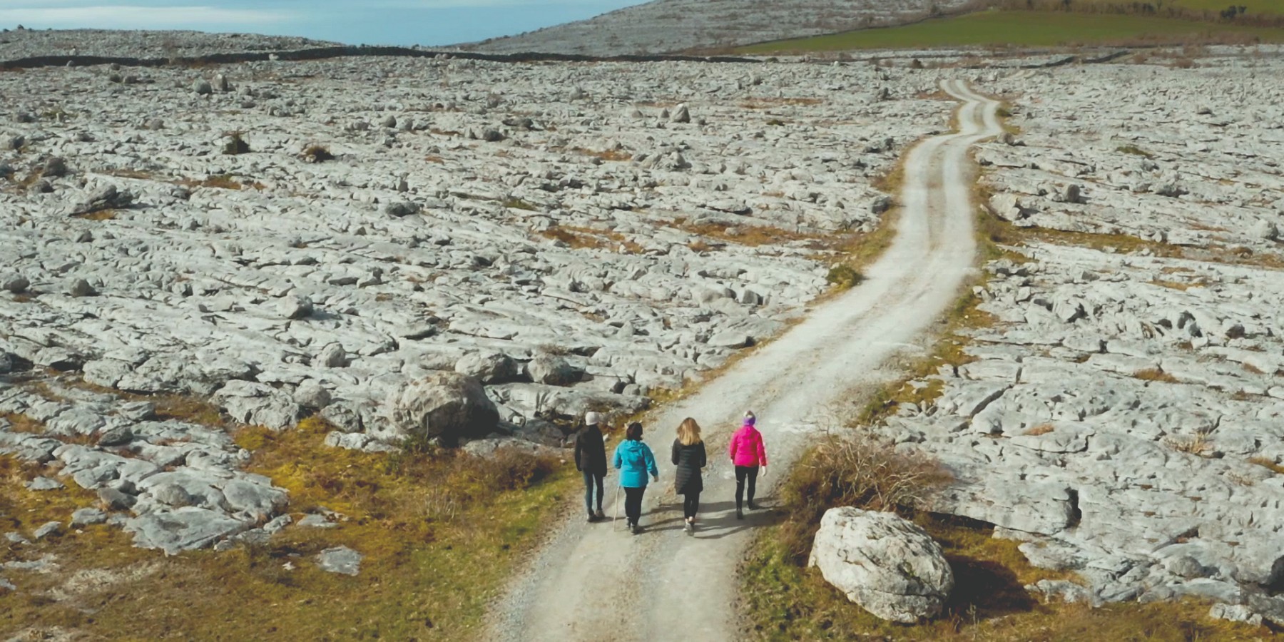 Travellers on Burren Walking Tour going through a rocky road
