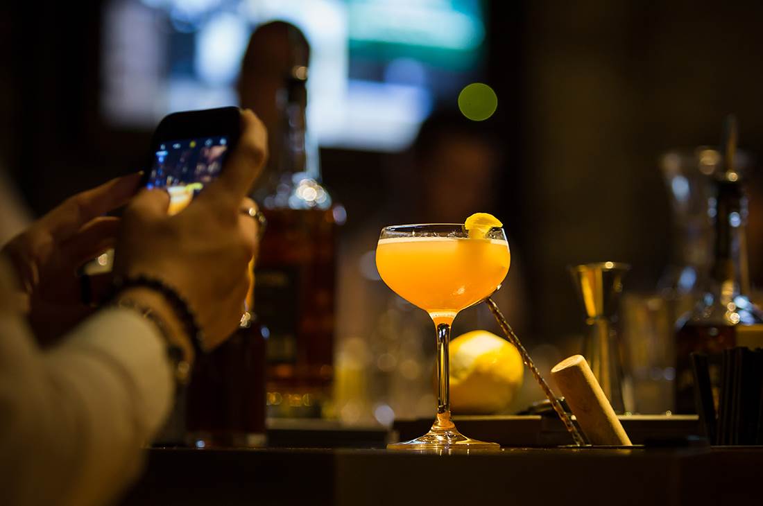 A person taking a picture of a drink