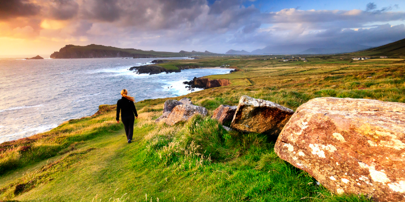 A person walking along a cliff in Ireland