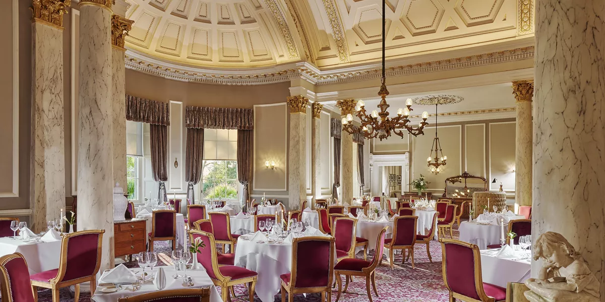 The Garden Room restaurant with square tables and red chairs in the Great Southern Hotel, Killarney
