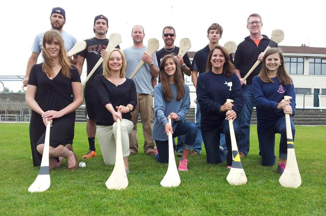A group of people holding paddles posing for a picture
