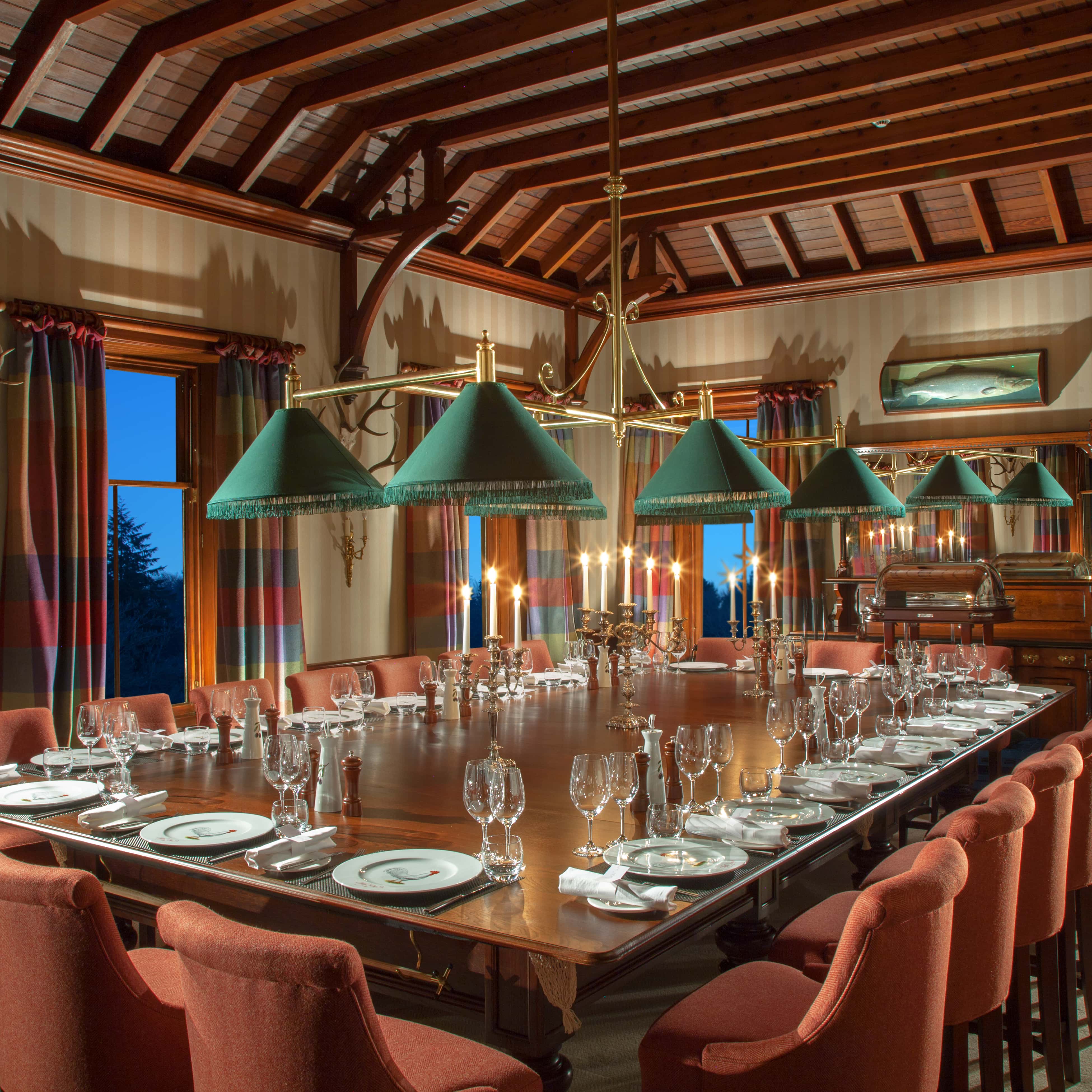 A dining room table with a lot of place settings