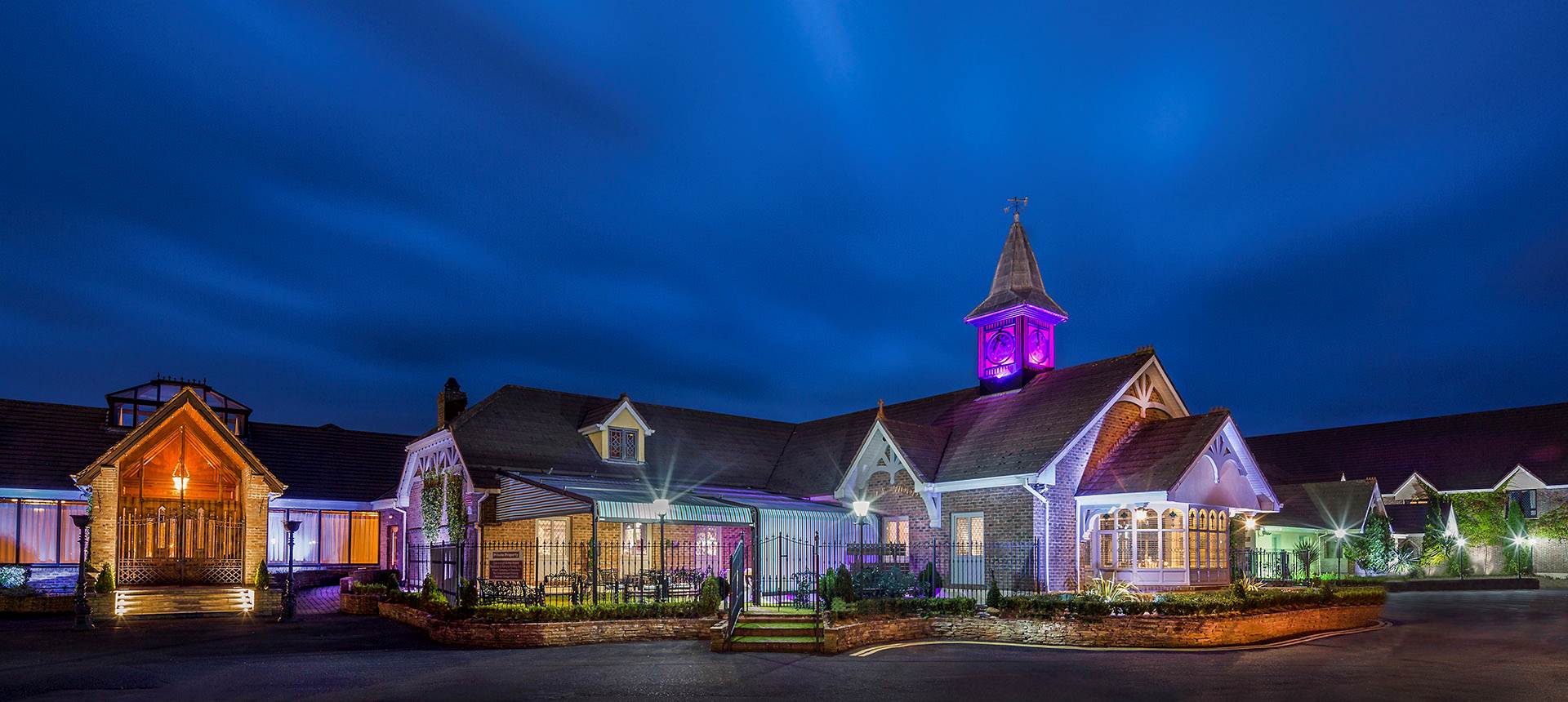 A building with a clock tower lit up at night