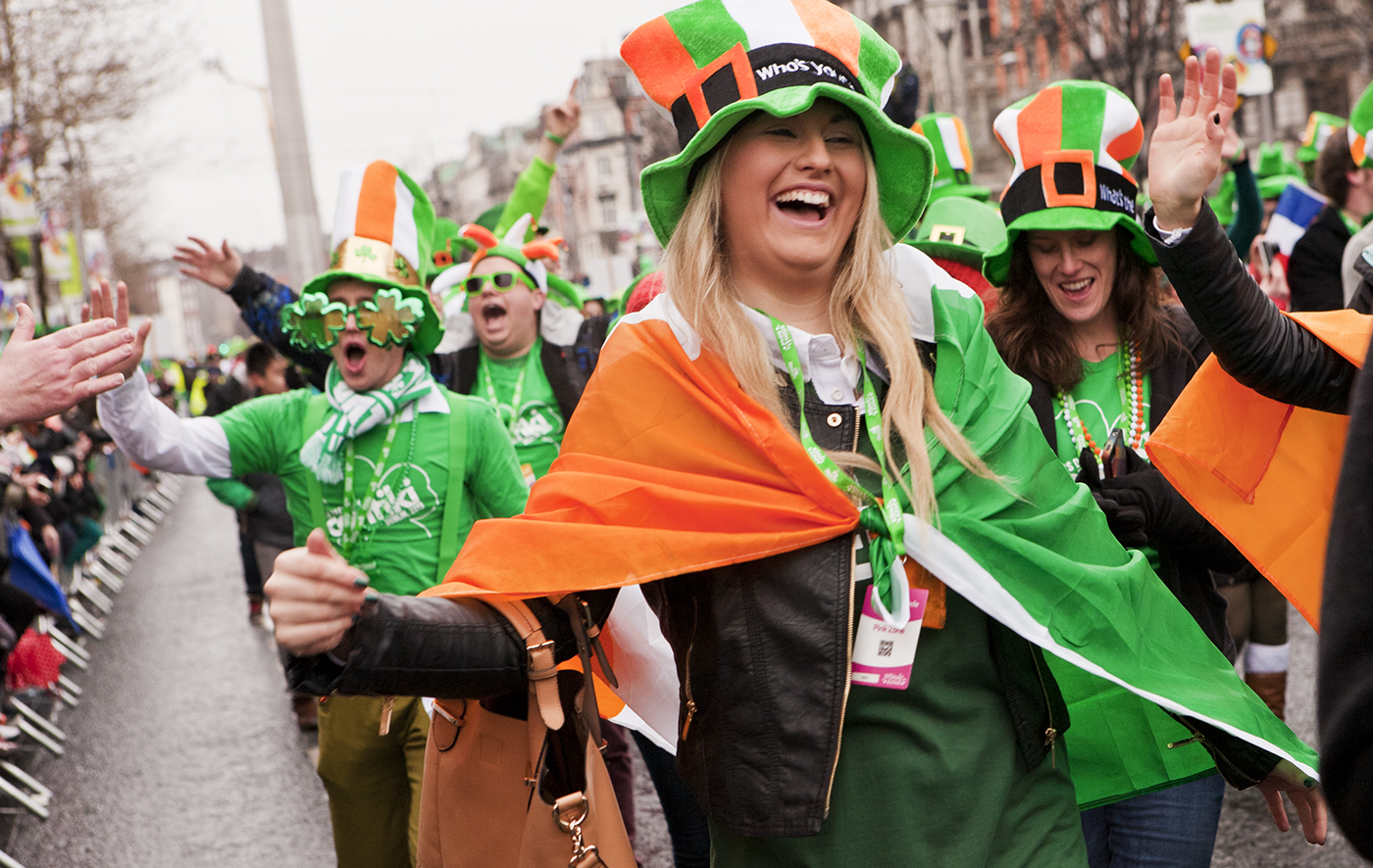People wearing leprechaun hats and Irish flags for St. Patrick's day celebrations in Dublin