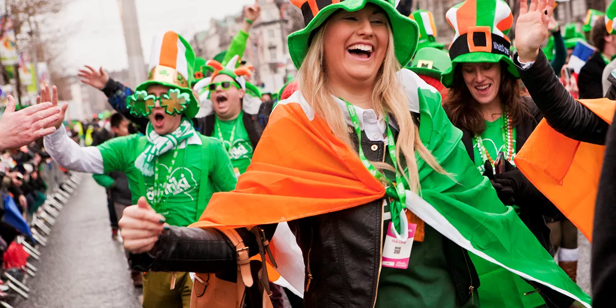 People wearing leprechaun hats and Irish flags for St. Patrick's day celebrations in Dublin