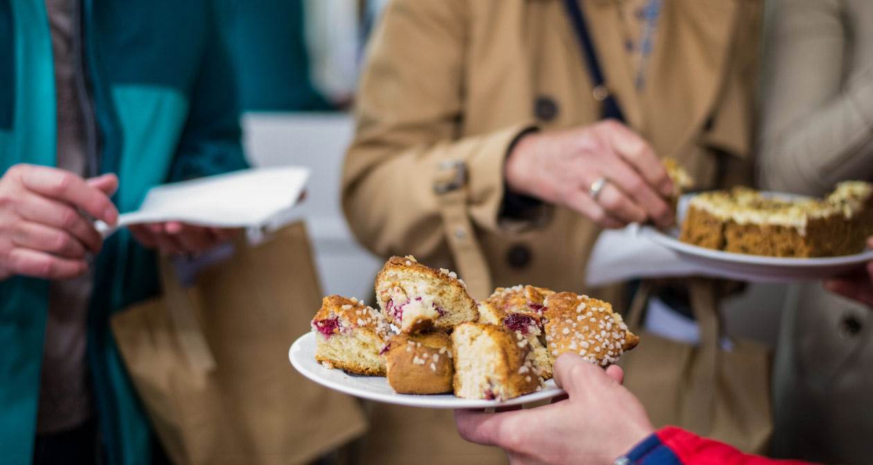 A group of people holding plates of cakes during Galway Food Tour
