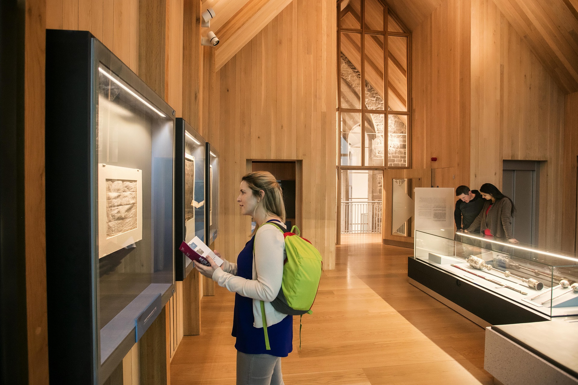 A tourist with a green backpack in Medieval Mile Museum in Ireland