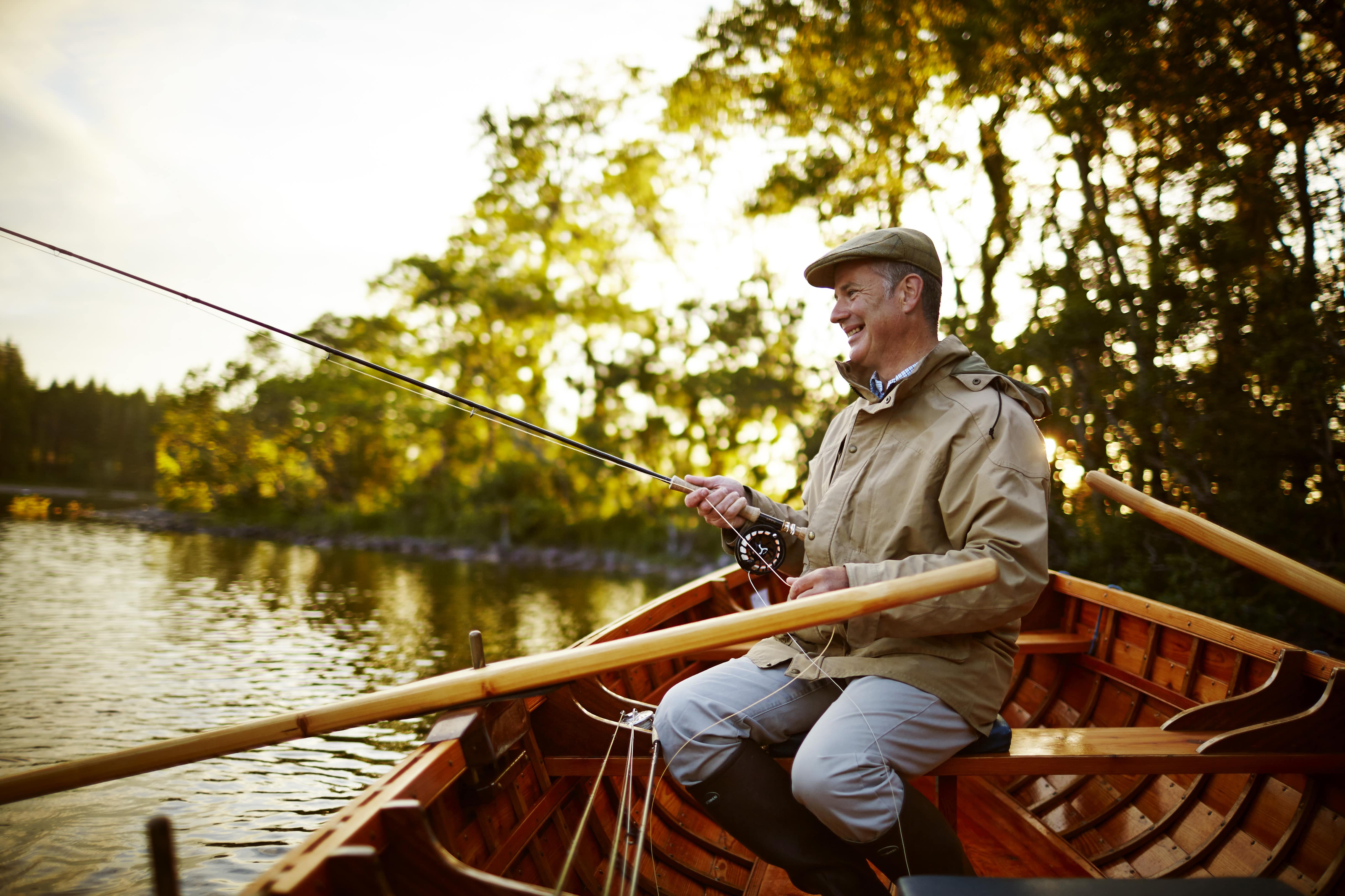 A man sitting in a boat and fishing