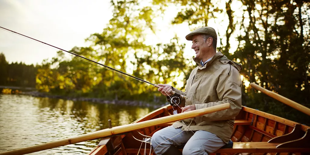 A man sitting in a boat and fishing