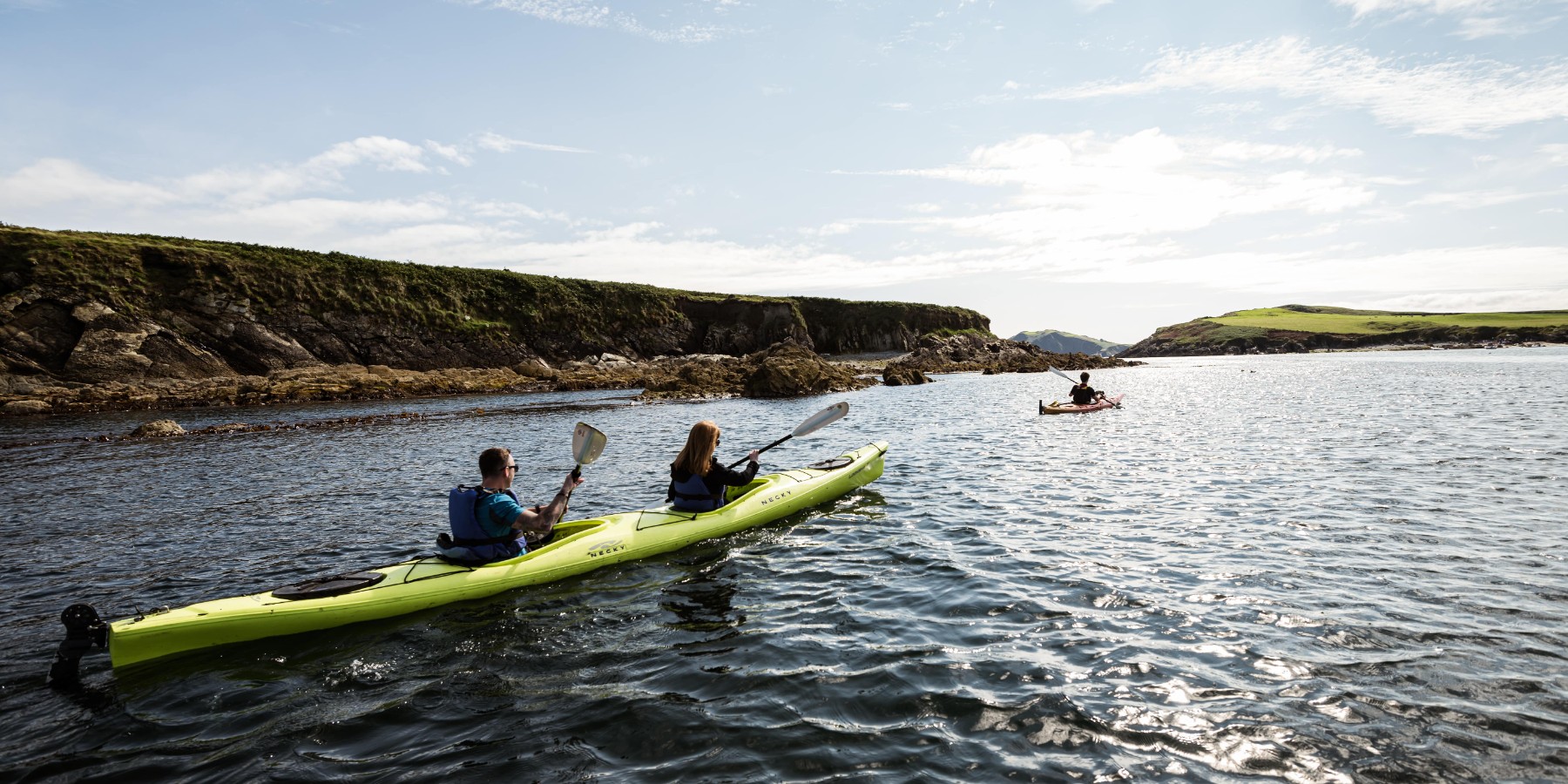 Kayakers rowing across the loch
