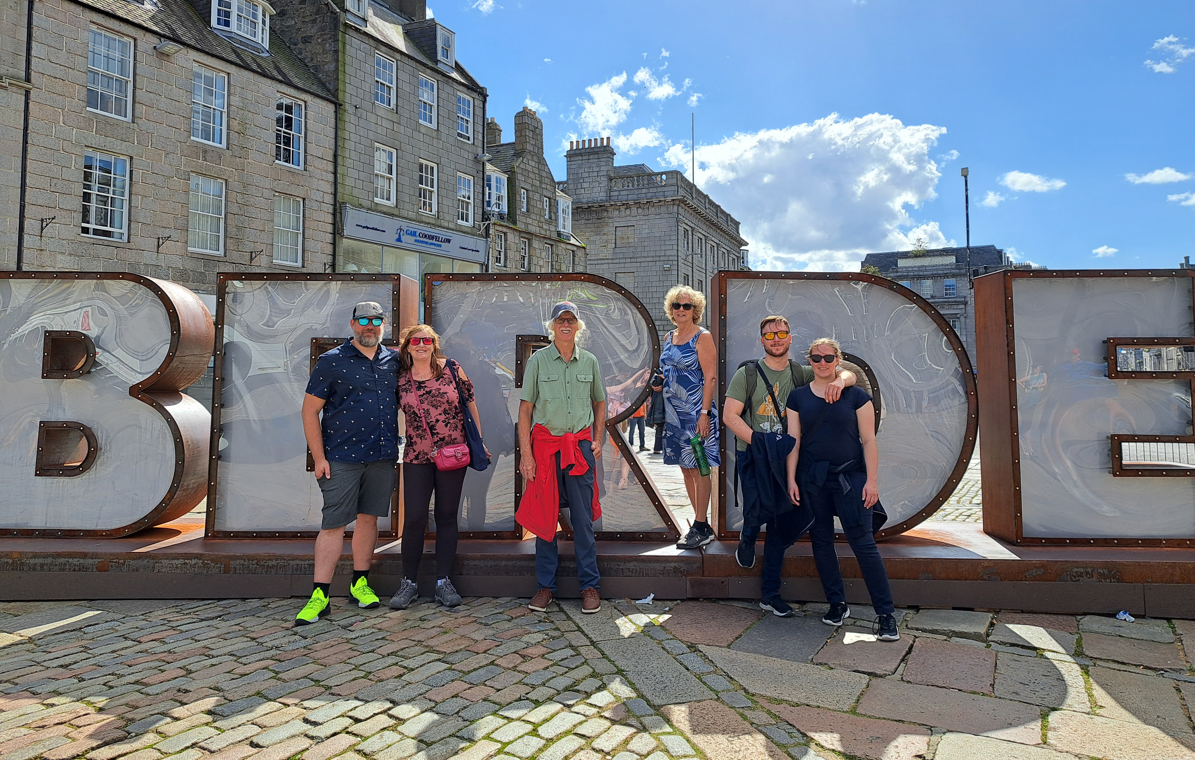 Statue with Aberdeen letters and people posing