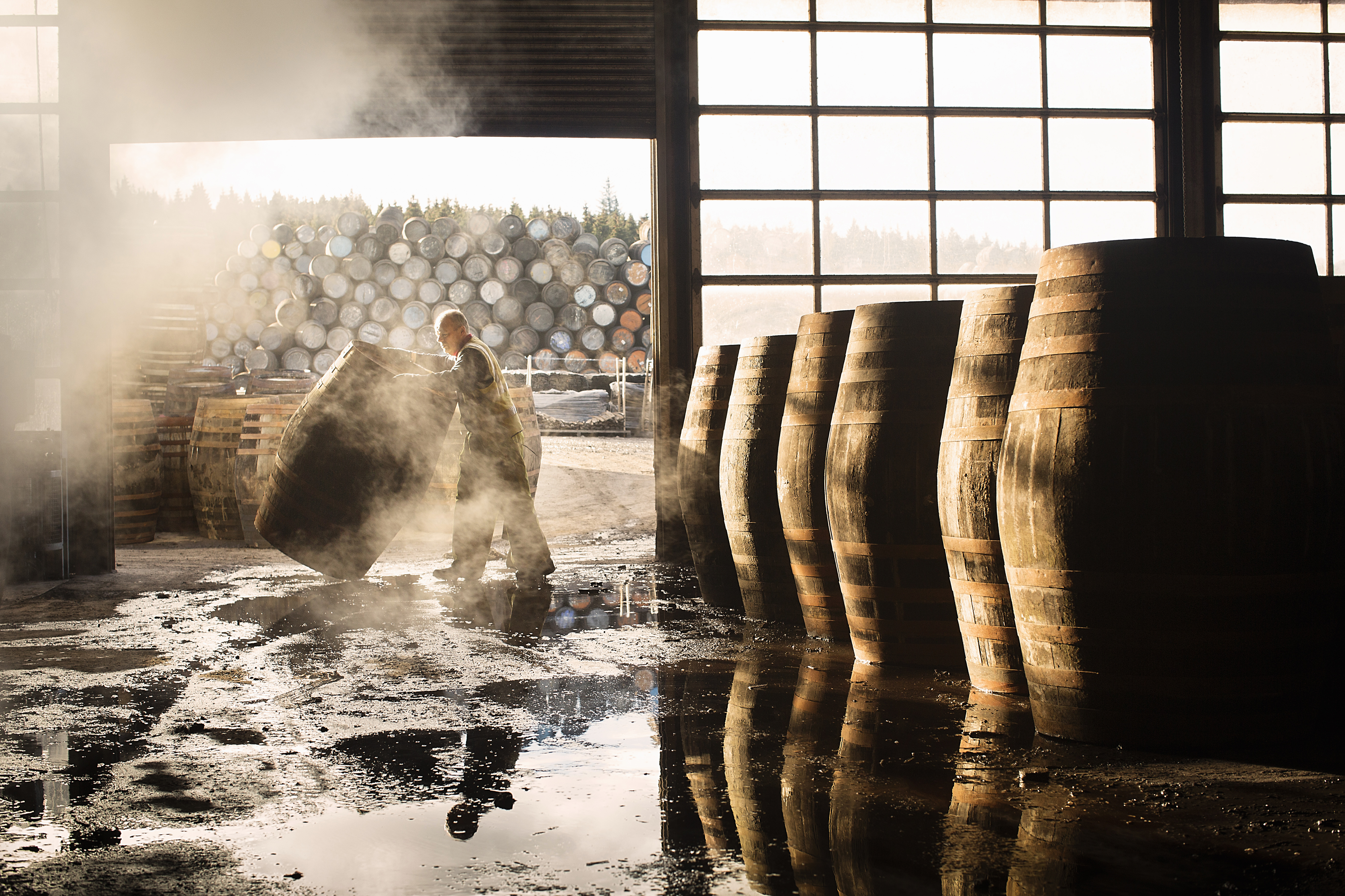 Man working with whisky casks
