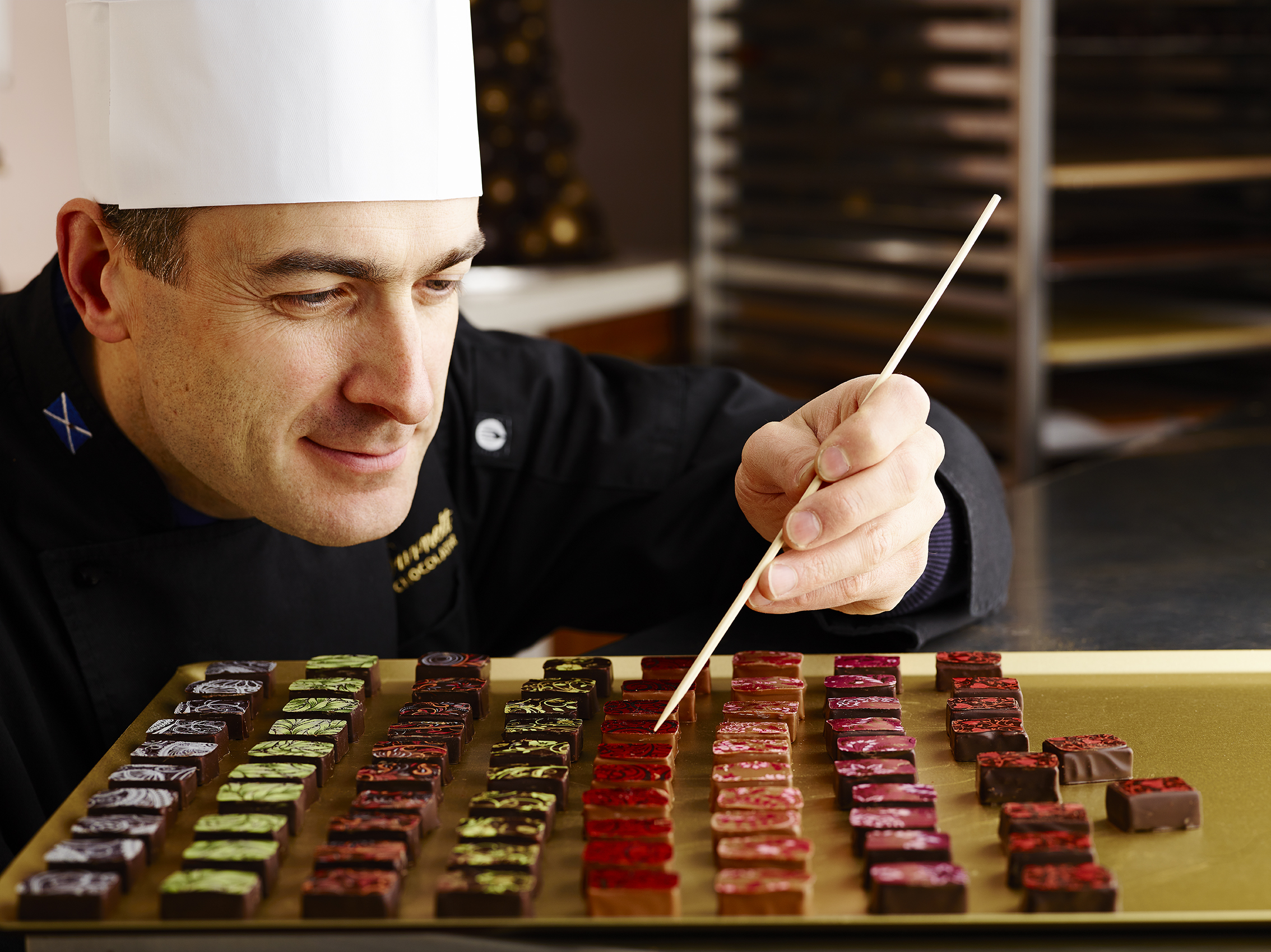 Iain Burnett shares his creations with guests during a private chocolate tasting experience in Scotland.