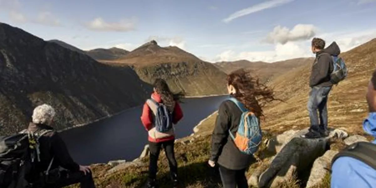 A group of people standing on top of a mountain