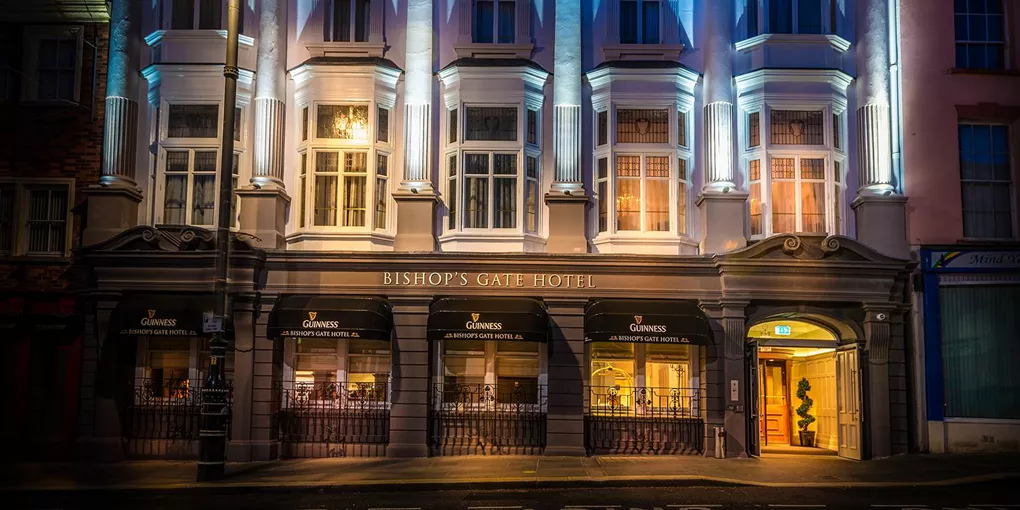 A tall building with many windows lit up at night