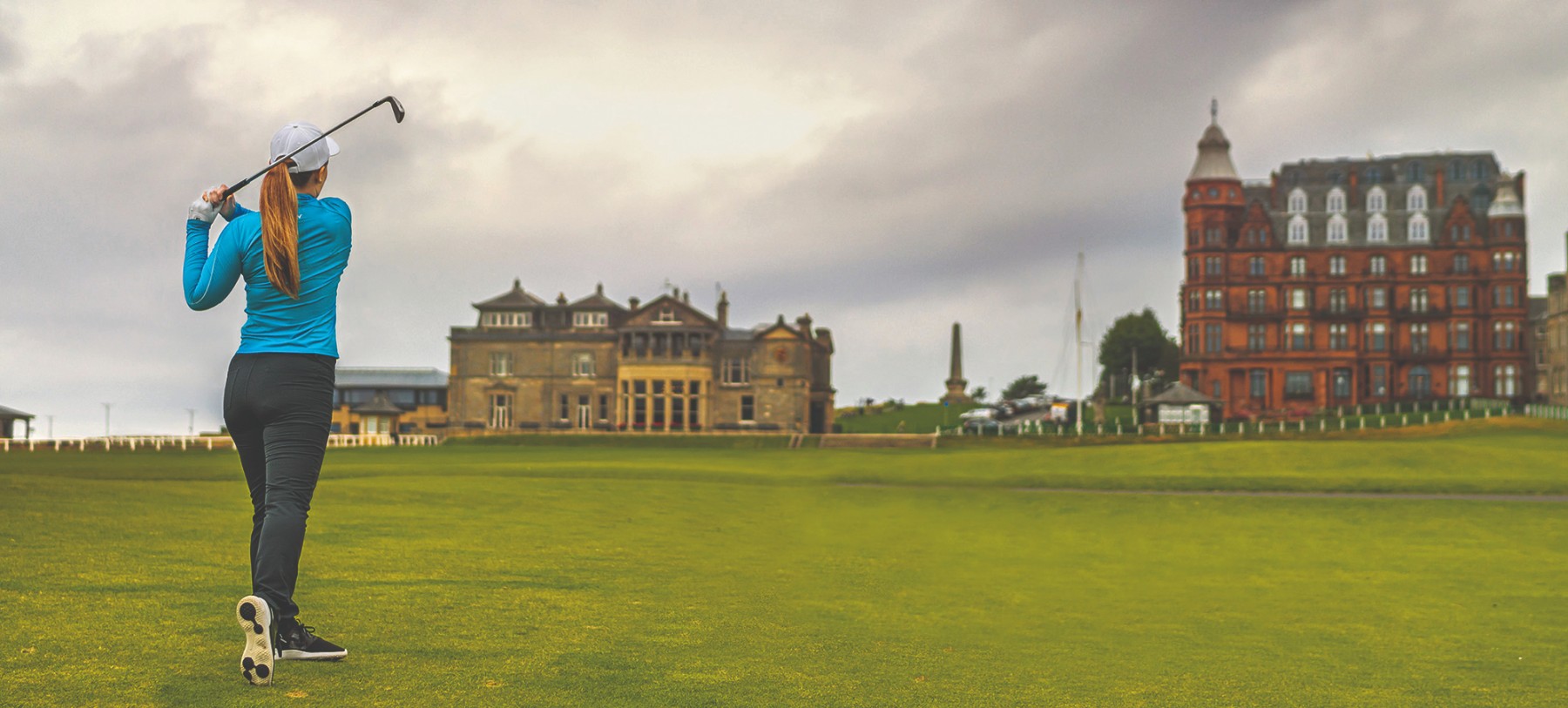A woman playing golf in St Andrews Old Course in Scotland
